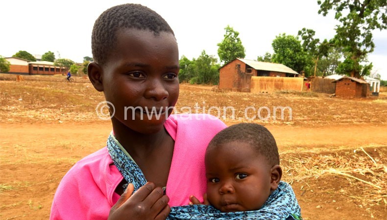 A child bride with her baby: Should marriage age be at 18 or 21? 