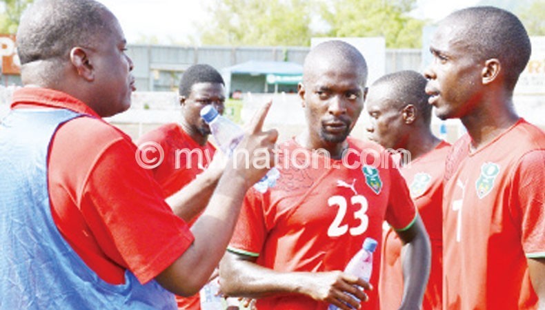 Chimodzi (L) tipping his charges during the recent friendly against Zimbabwe