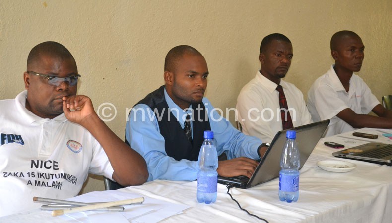 Kumwenda (L) and some officials at the training