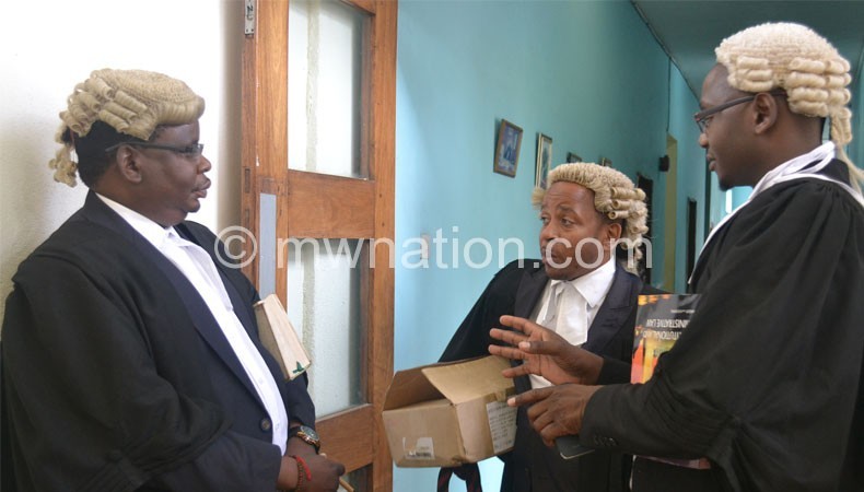 Lawyers Zolomphi Nkowani (L), Chalamanda (C) and Mbeta outside the judge’s chamber yesterday