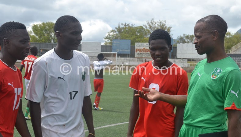 Mtawali (R) shares notes with some of his players