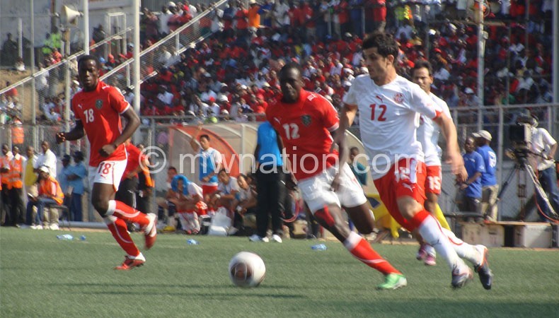The Flames (in red) in action against Tunisia in 2011 at Kamuzu Stadium