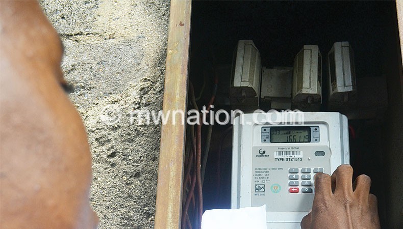 A customer loading electricity units on a pre-paid billing meter