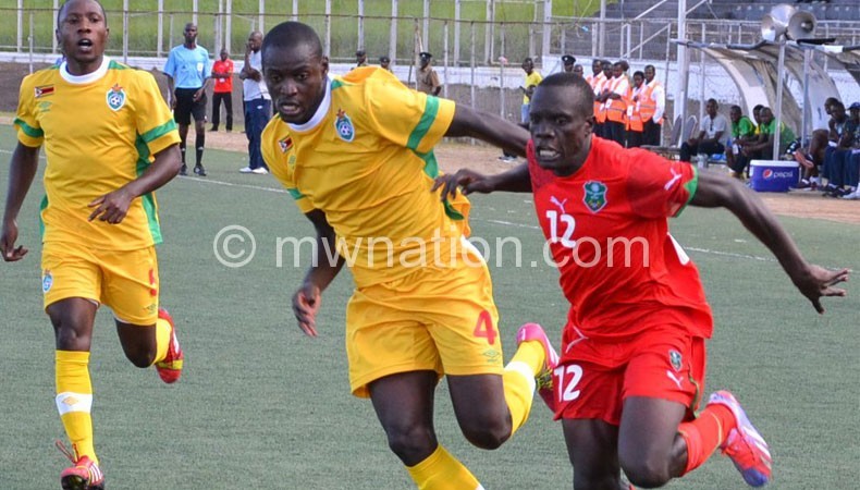 Flashback: Flames’ Chimango Kayira (R) in battle with Zimbabwean players in a recent friendly
