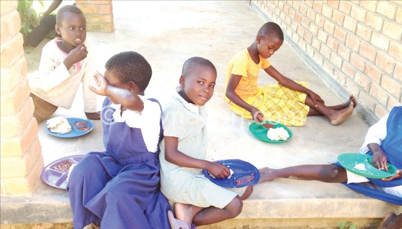 Some of the pupils at Bandawe School for the Deaf enjoy a meal