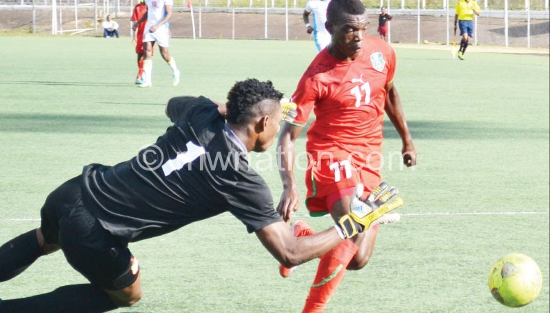 Kawonga (R), one of the Under-20 players being targeted by the senior Flames captured challenging a Chad goalkeeper