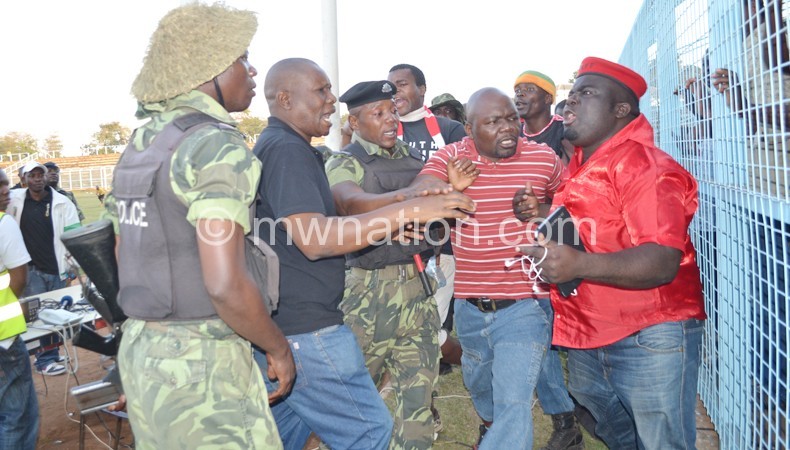 Osman (R) being restrained from getting physical with security officers