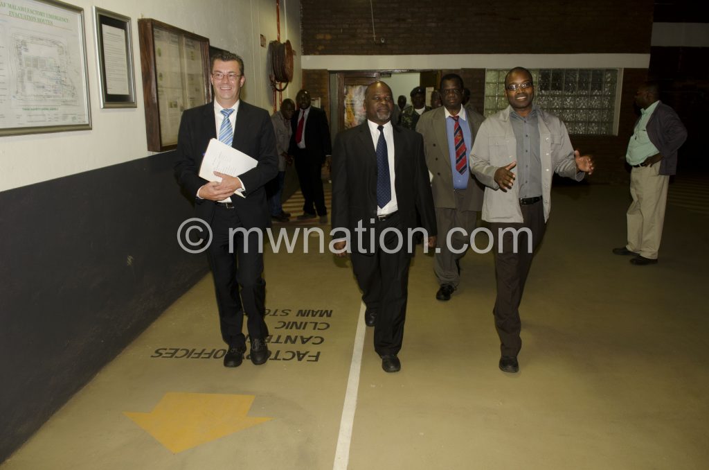 Agriculture Minister Dr Allan Chiyembekeza  flanked by  JTI Managing Director Fries Vanneste and Factory Operations Director Taurai Tongoona during the tour