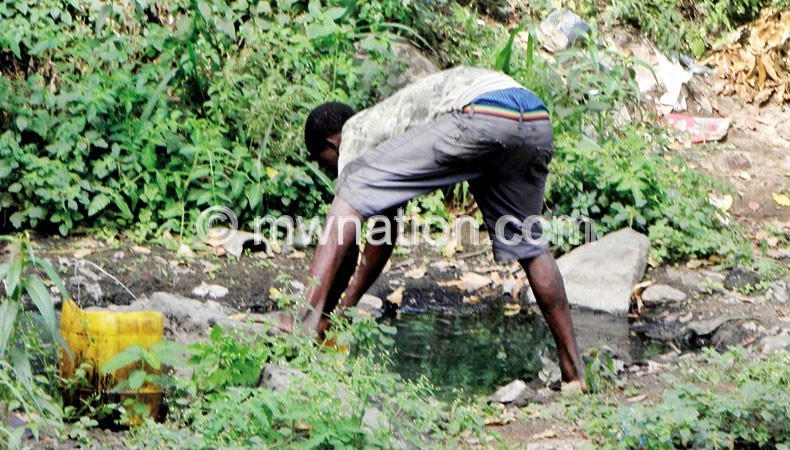 Cashing in: A casual labourer drawing water to sell to vendors at the market general usage