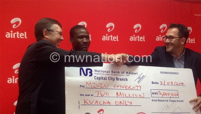  Airtel Malawi MD Heiko Schlittke hands over a dummy cheque to Mzuni's Vice Chancellor Robert Ridley