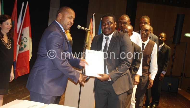 Chilima (L) presenting certificates to graduates