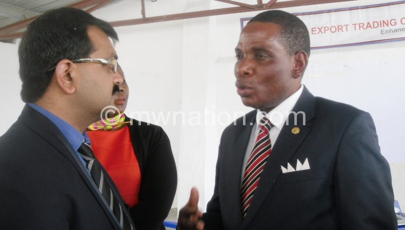 Mwanamvekha (R) interacts with officials of ETG during Trade Fair in Malawi