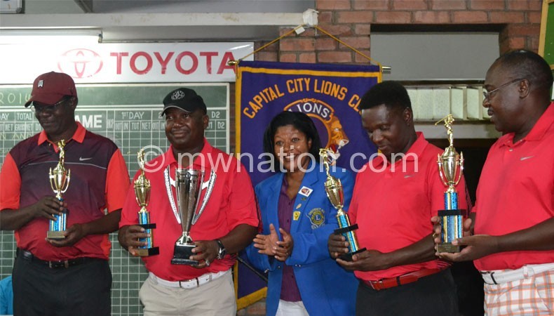 The MDF team that won the tournament pose with Lion Gunda (C)