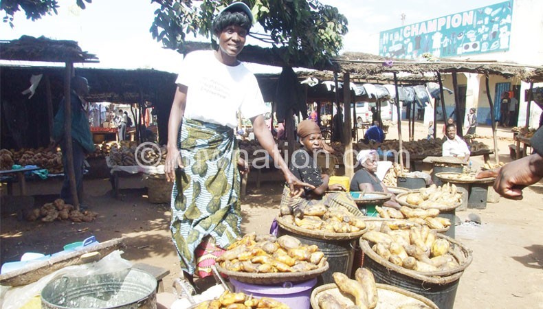Nyama selling boiled potatoes  at Mponela Trading Centre