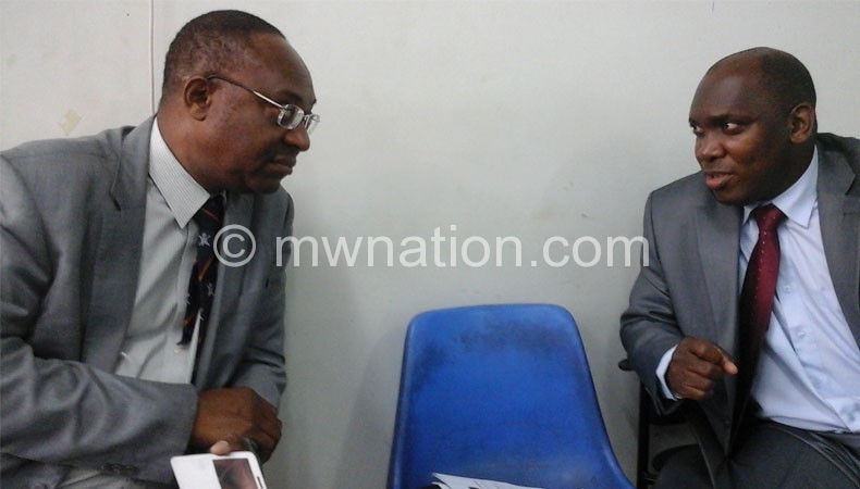 Samukange (left) confers with a colleague Ernest Manyawu