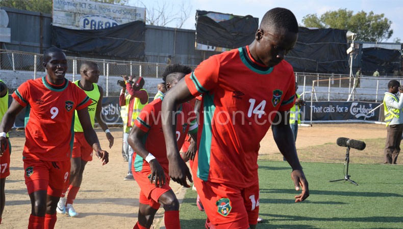 It's still a tall order: Limbikani Mzava (No. 14) seems to think after celebrating a goal at Kamuzu Stadium