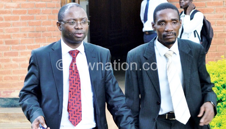 Kasambara (L) and well-wisher leaving court on Thursday 