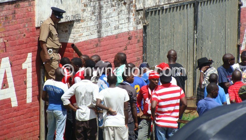 Fans queue to pay for entry into Kamuzu Stadium to watch a game