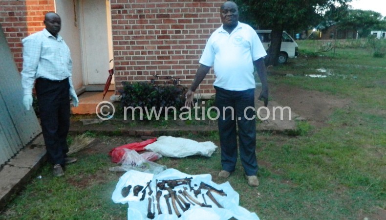 Chidothi (R) points at the human bones which were discovered in a maize field near the Ntaja Police Station