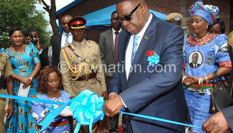Mutharika cutting a ribbon marking the official opening of Ngara Community College in Karonga
