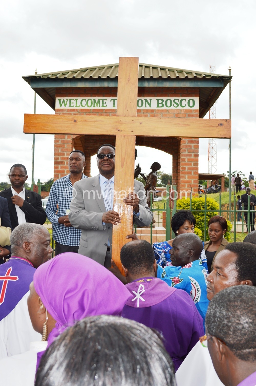 President Mutharika holds the Cross at the last Station of the Cross way - Pic by Stanley Makuti