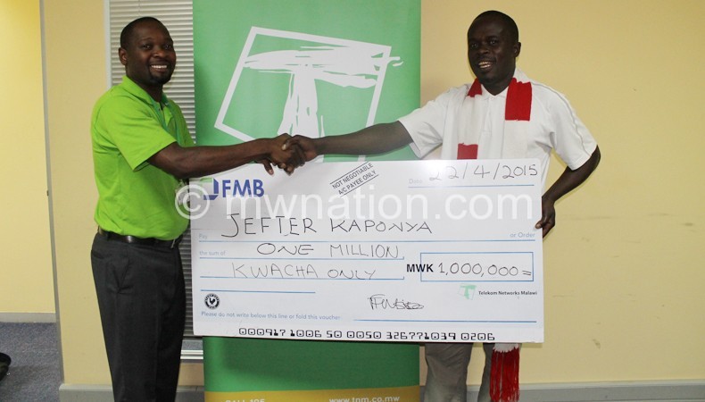 All smiles: Kaponya (R) receiving cheque from Nsapato