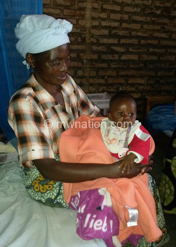 Baby Emmy with a carer at the care center