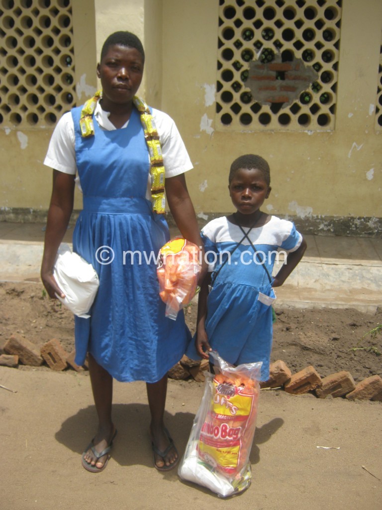 Gloria Bush with her Standard Two child captured outside Standard Seven classroom 