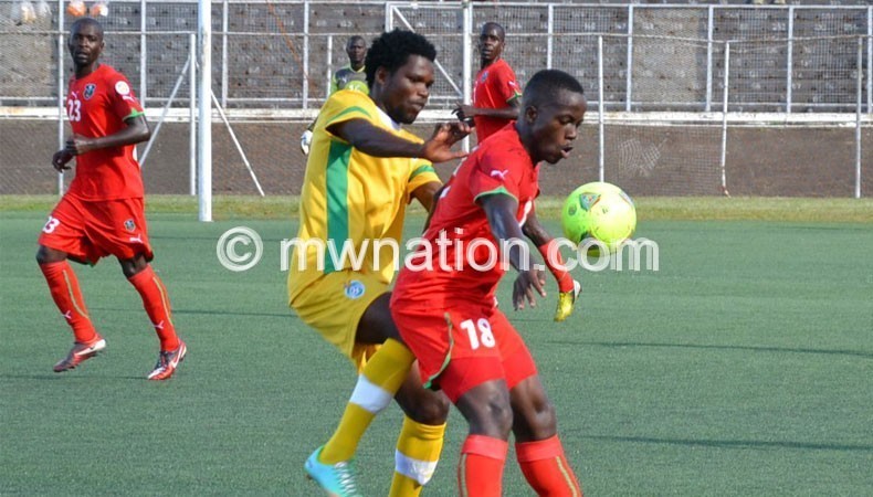 Atusaye Nyondo (R)  shields the ball from a Zimbabwean player during last year’s friendly match