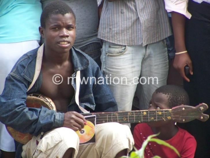 Gwaladi at work selling his music in Limbe