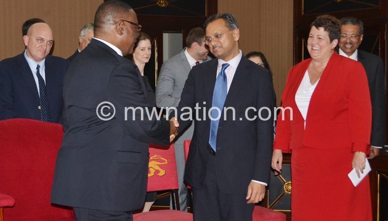 Mutharika bids farewell to Khan as US Ambassador Virginia Palmer (R) looks on