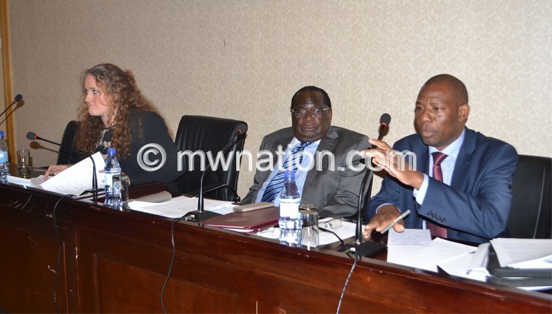 Secretary to the Treasury Ronald Mangani (R) addressing the meeting as Gondwe (C)  and Marshall listen