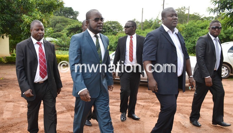 Mphwiyo (2nd from L) with sympathisers during an  earlier court appearance