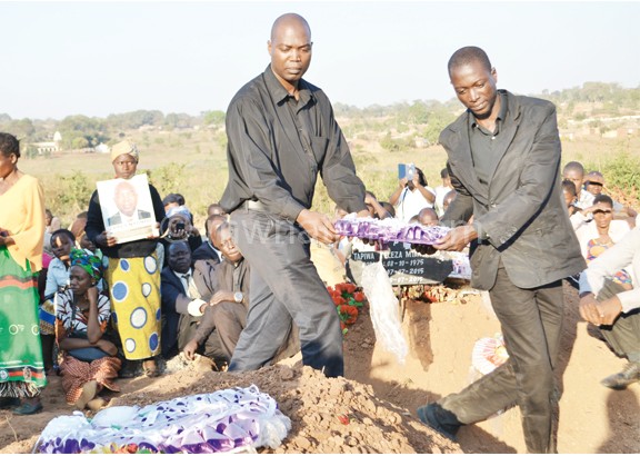 Nyondo’s brothers about to lay a  wreath on his grave