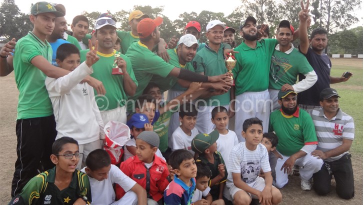 Chaudhry holding trophy (C) in white cap celebrates with  teammates after last year’s contest 