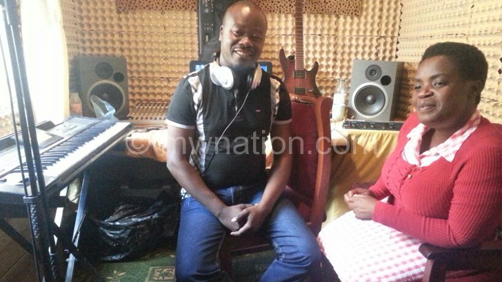 Joseph Tembo (L) at work in the studio with gospel singer Grace Chinga 