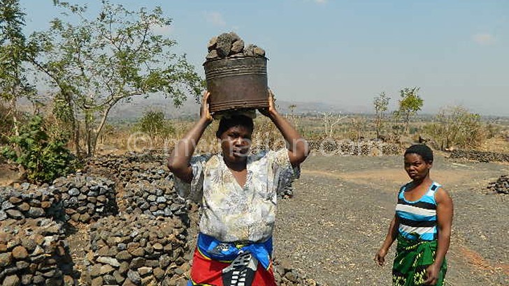 Women captured where they pile the stones in one-tonne heaps