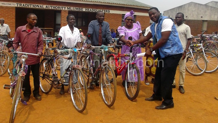 Mwandira handing over bicycles to community educators