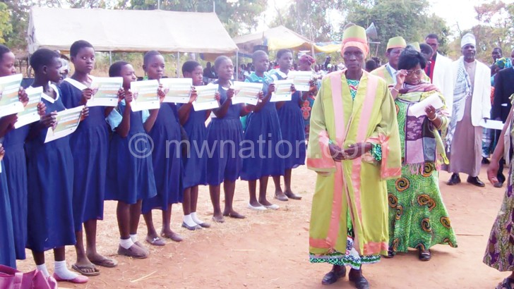 Mwanza (R) inspects some of the girls vowing to remain in school