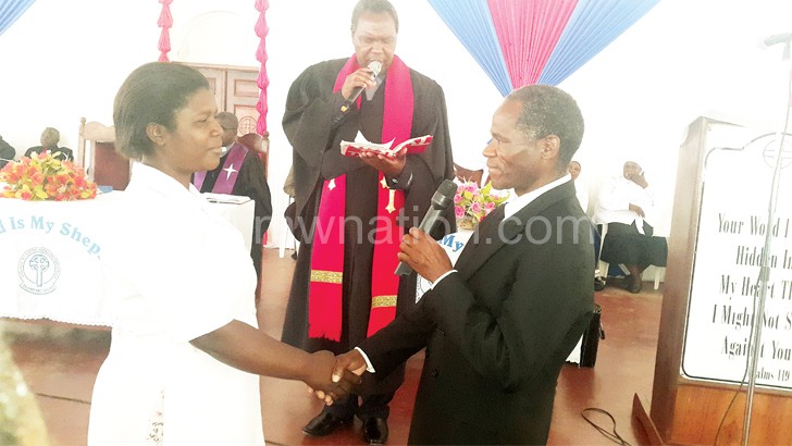 Reverend Ernest Mpate presides over renewal  of vows by one of the couples