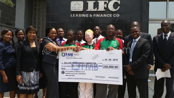 LFC’s Sithembile Sisya (2nd L) presents cheque to Chiutsi as other officials look on