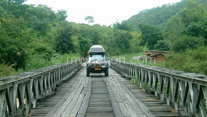A single-lane bridge with woooden planks on the Mzuzu-Nkhata Bay Road