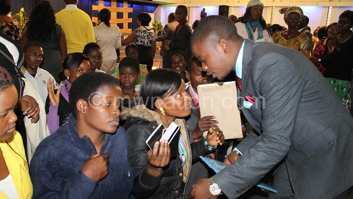 Bushiri (R) interacts with some of his believers