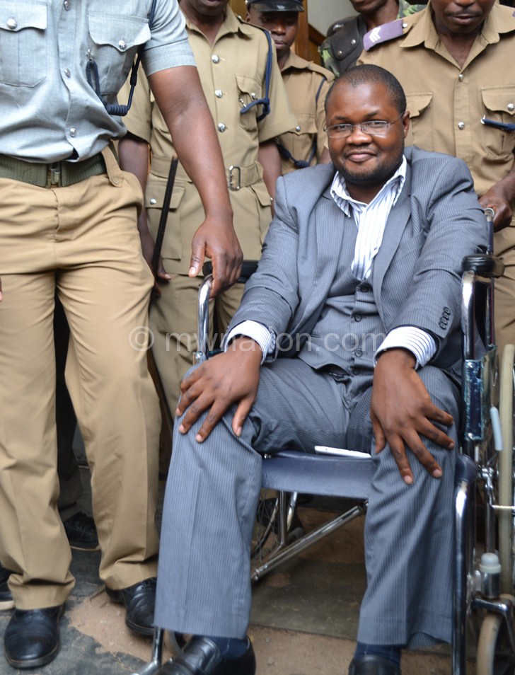 In one of his many court appearences before the conviction: Lutepo (seated on the wheelchair)
