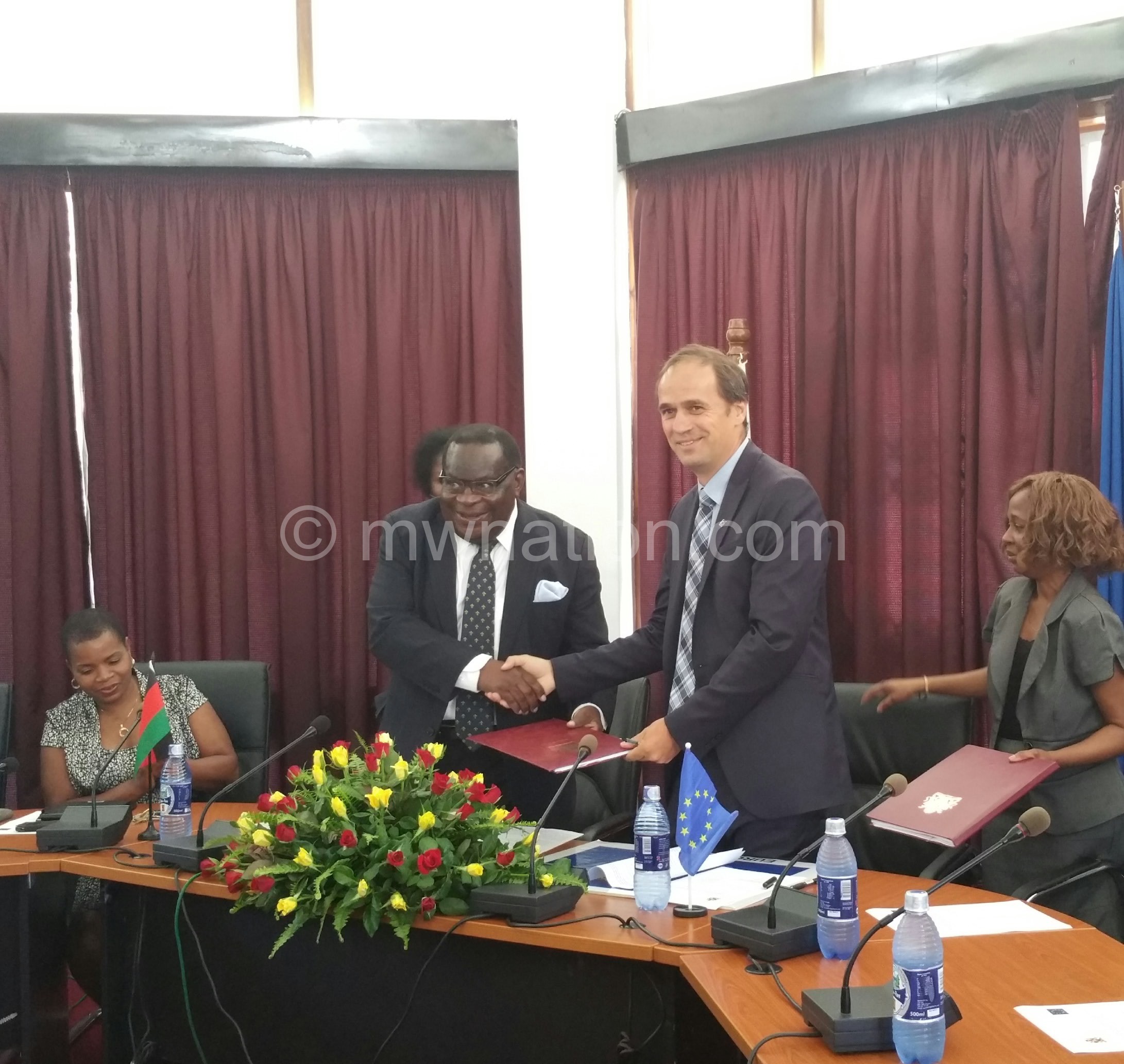 EU head of delegation to Malawi Marchel Gerrmann (R) and Minister of Finance Goodall Gondwe (L) exchanging signed agreements
