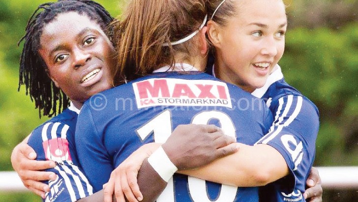 Chawinga (L) celebrates her moment of glory with teammates 