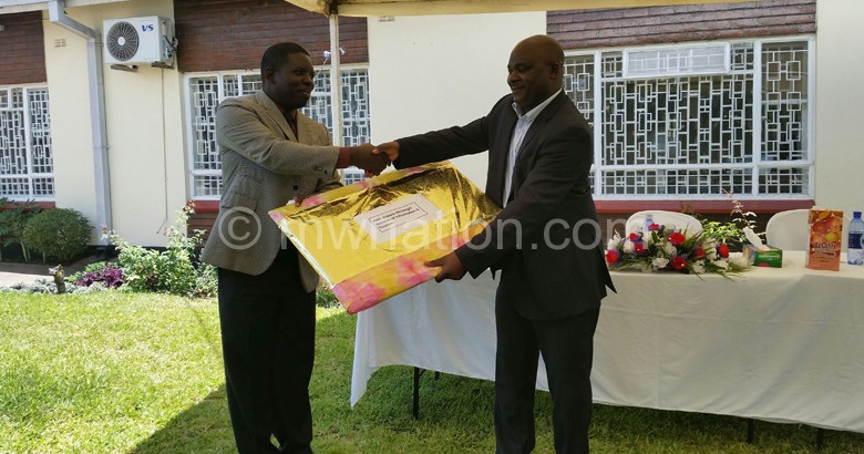 Mhango(R) recieves a gift from Banda(L)