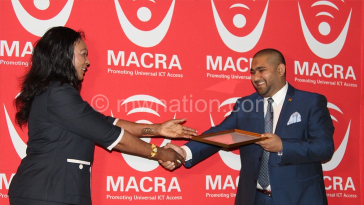 Here you are: Macra board chairperson Alisha Makawa presents the licence to Sattar (R) on Monday  