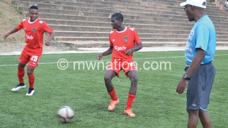 Flames players and assistant coach Nsanzurwimo Ramadhan (R) captured during training