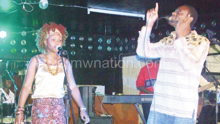 Menes (R) belts out a number during his performance in Mzuzu